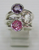 sterling silver Amethyst , white topaz and pink topaz rings worn together.