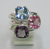 sterling silver Blue topaz, pink topaz and amethyst rings worn together.