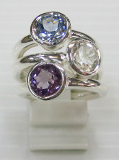 sterling silver Blue topaz , white topaz and amethyst rings worn together.