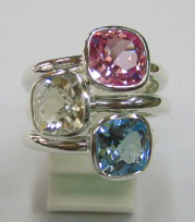 sterling silver Pink, white and blue topaz rings worn together.